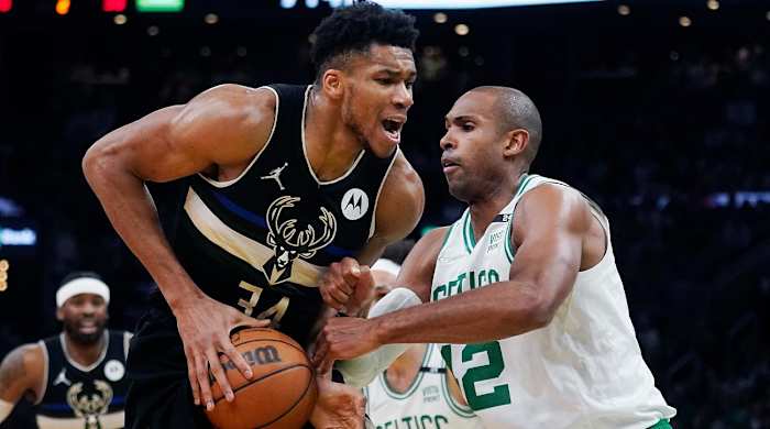 Boston Celtics center Al Horford (42) stops Milwaukee Bucks forward Giannis Antetokounmpo, left, on a drive to the basket during the first half of Game 5 of an Eastern Conference semifinal in the NBA basketball playoffs, Wednesday, May 11, 2022, in Boston.